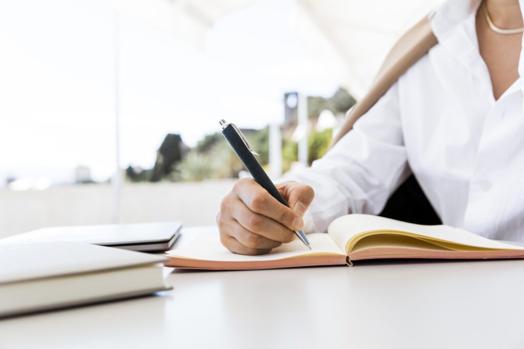 close-up-woman-writing-notebook